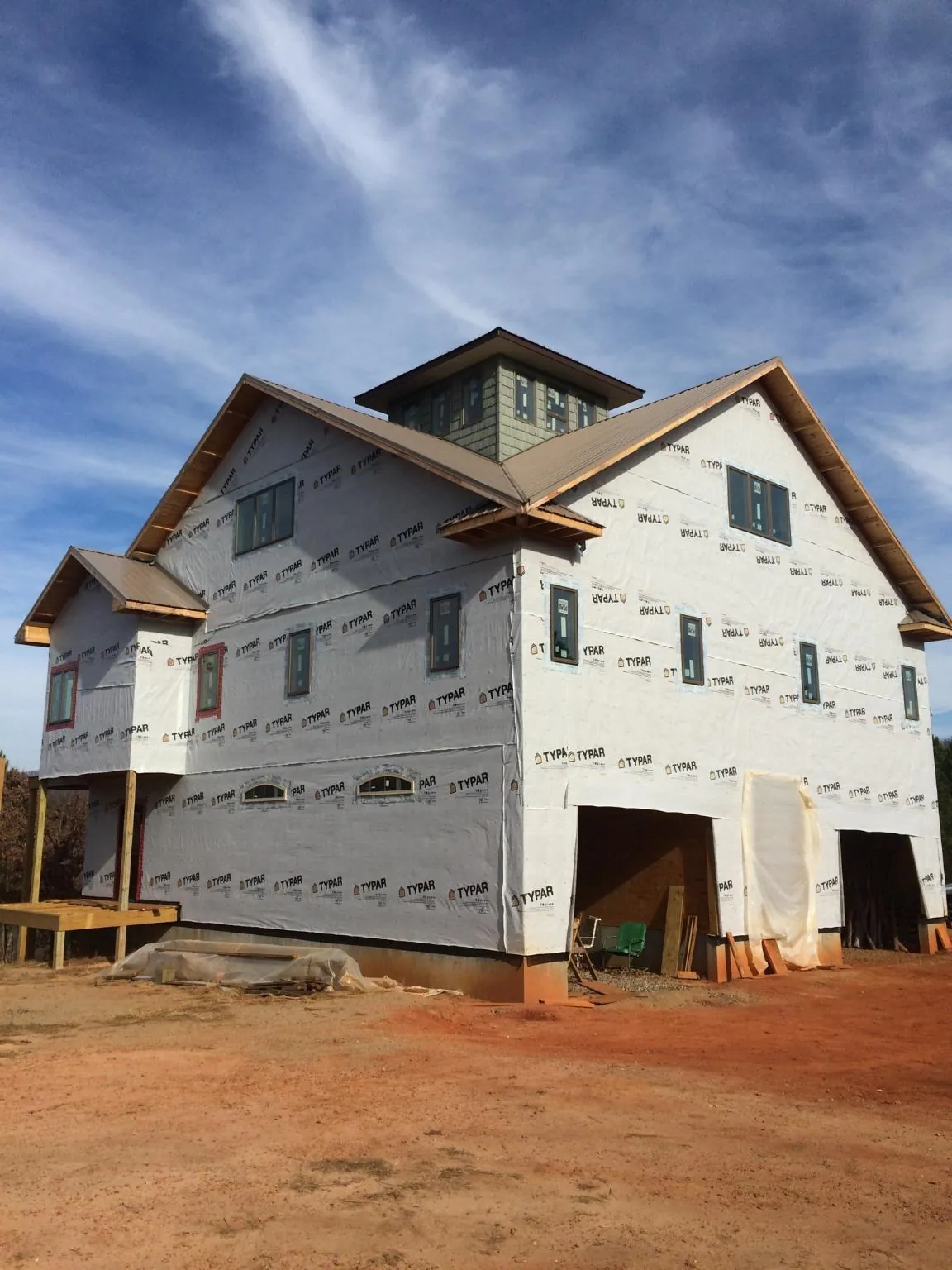 New two story house under construction with a cupola and gabled roofs in Cold Spring Harbor